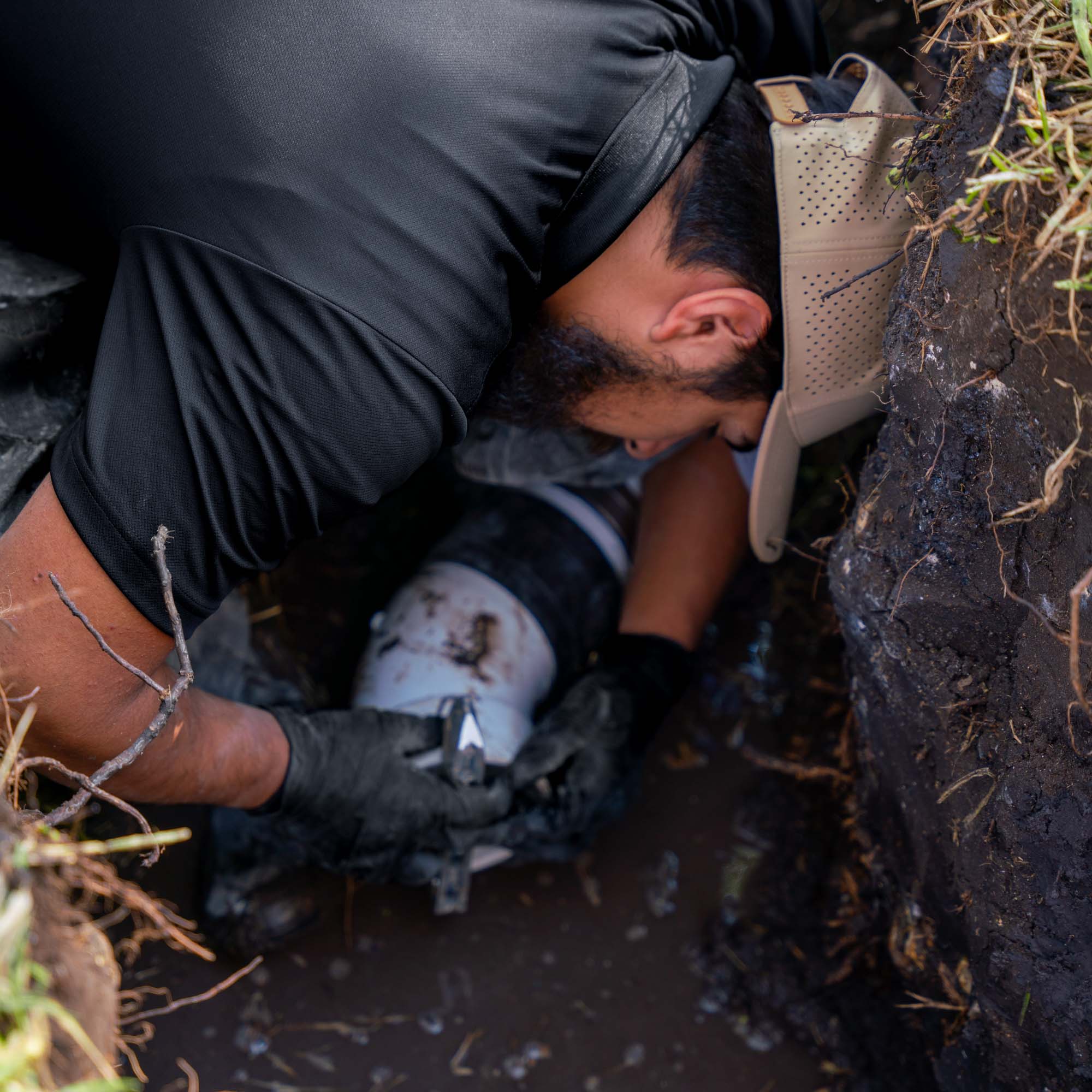 The Bearded Plumber technician working on an underground sewer line